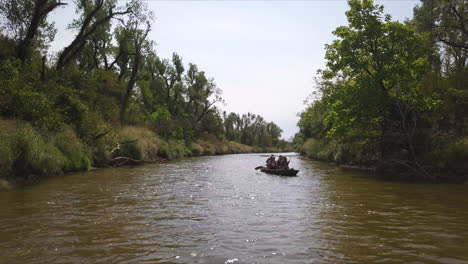 people kayaking in peaceful quiet river, exploring wild nature
