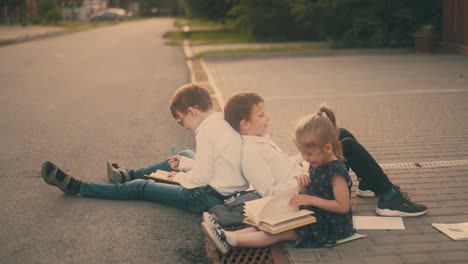 children prepare for difficult exam on street pavement