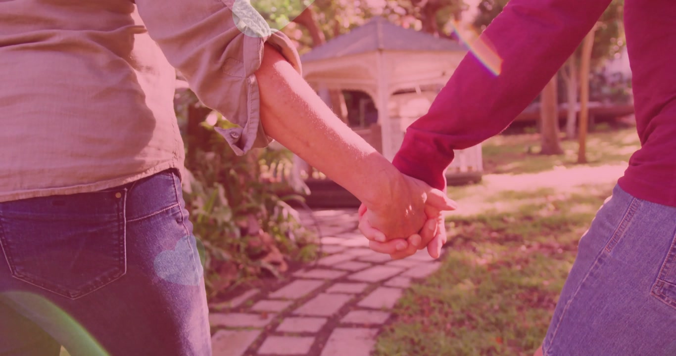 Marketing showing couple walking path turning wrists to clasp hands adding heart graphics to gazebo