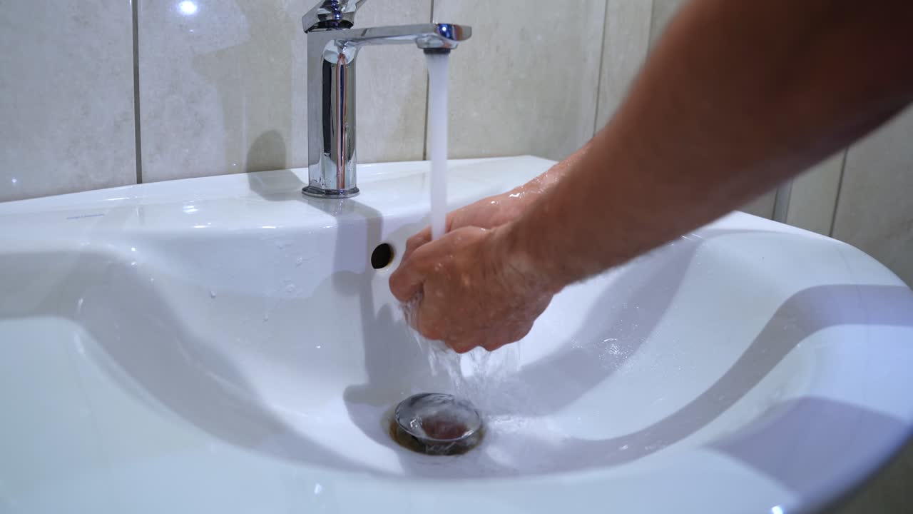 Realistic close-up of hands rinsing under running tap. Great for hygiene, cleaning routines, or health campaigns.