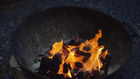 burning charcoal in old barbecue grill for an evening gathering with friends