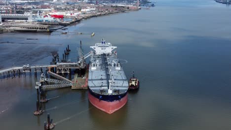 crude oil tanker ship loading at refinery harbour terminal aerial high angle view