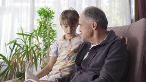 Knowledgeable-grandfather-and-clever-grandson-reading-a-book.