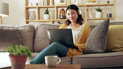 Laptop,-remote-work-and-Asian-woman-on-sofa