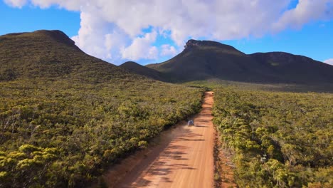 Aerial-follow,-car-driving-through-lush-landscape,-Western-Australia