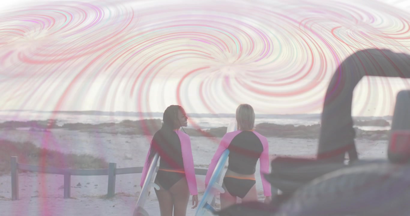 Two female surfers entering shot at sunset with surfboards walking toward ocean with pastel overlay