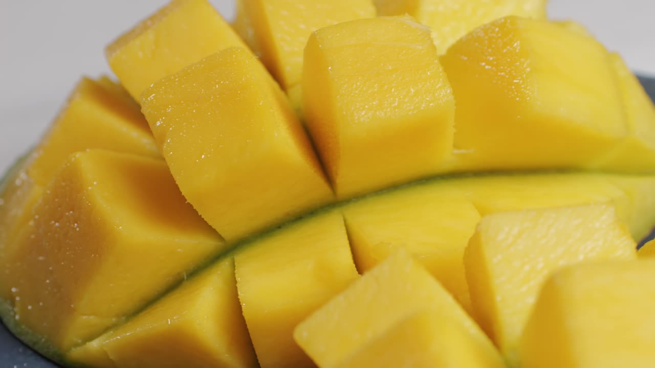 Close up rip mango slice cubes cut. High quality 4k footage