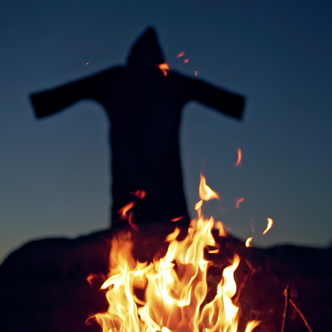 Evil witch conjures in the wizarding lair. Scary Halloween concept. Burning fire.