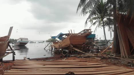 flying backwards at local boat construction site at indonesia, aerial