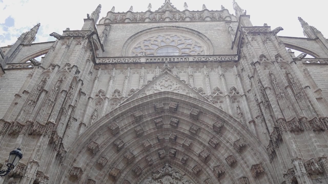 Seville Cathedral entrance next to Puerta de la Asuncion in Avenida de la Constitución. Impressive arch and columns decorations.