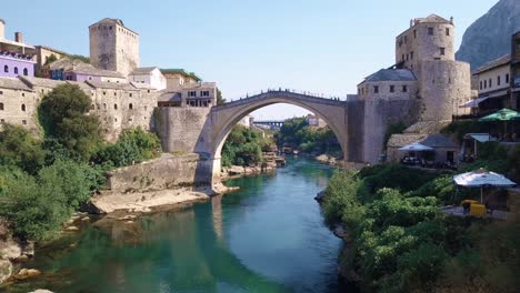 flying directly under iconic "stari most" old bridge in mostar