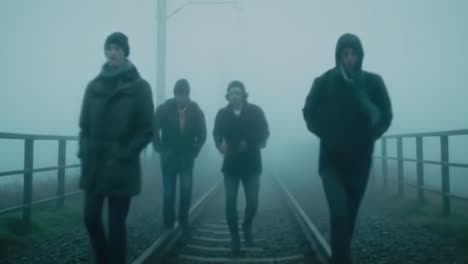 a mysterious group navigates foggy train tracks, evoking a sense of journey and adventure amidst an ethereal landscape of mystery and uncertainty