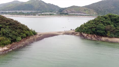 Hong-Kong-bay,-with-a-strip-of-sand-connecting-small-natural-islands,-Aerial-view