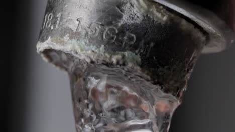 hard water problems: water flowing from tap close up