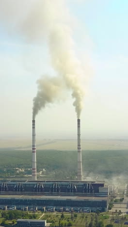 air polluting factory. factory with two chimneys and smoke