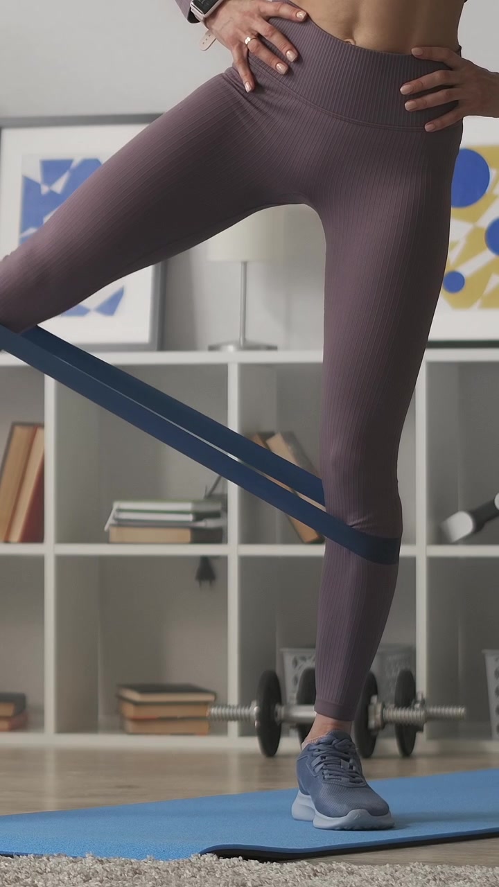 Woman's Legs Performing Leg Raises with Resistance Band