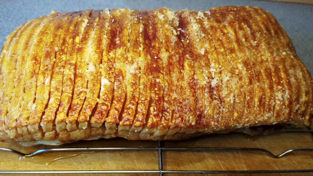 4K60 Danish Food Pork Loin With Crispy Skin, Resting Before Cutting It - Handheld Truck Shot
