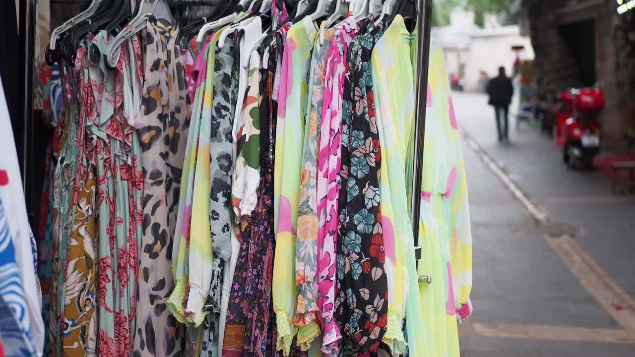 vestidos coloridos exhibidos en un mercado al aire libre