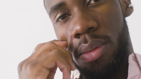 close up of man cleaning his tears while cries