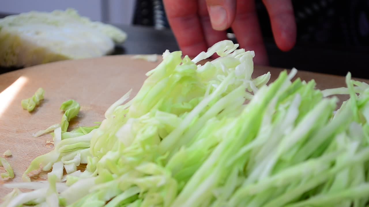 The cook cuts cabbage. Technology are sharp cabbage