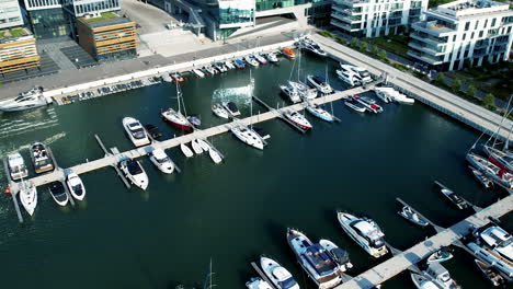 overhead view of docked sailboats in an urban marina