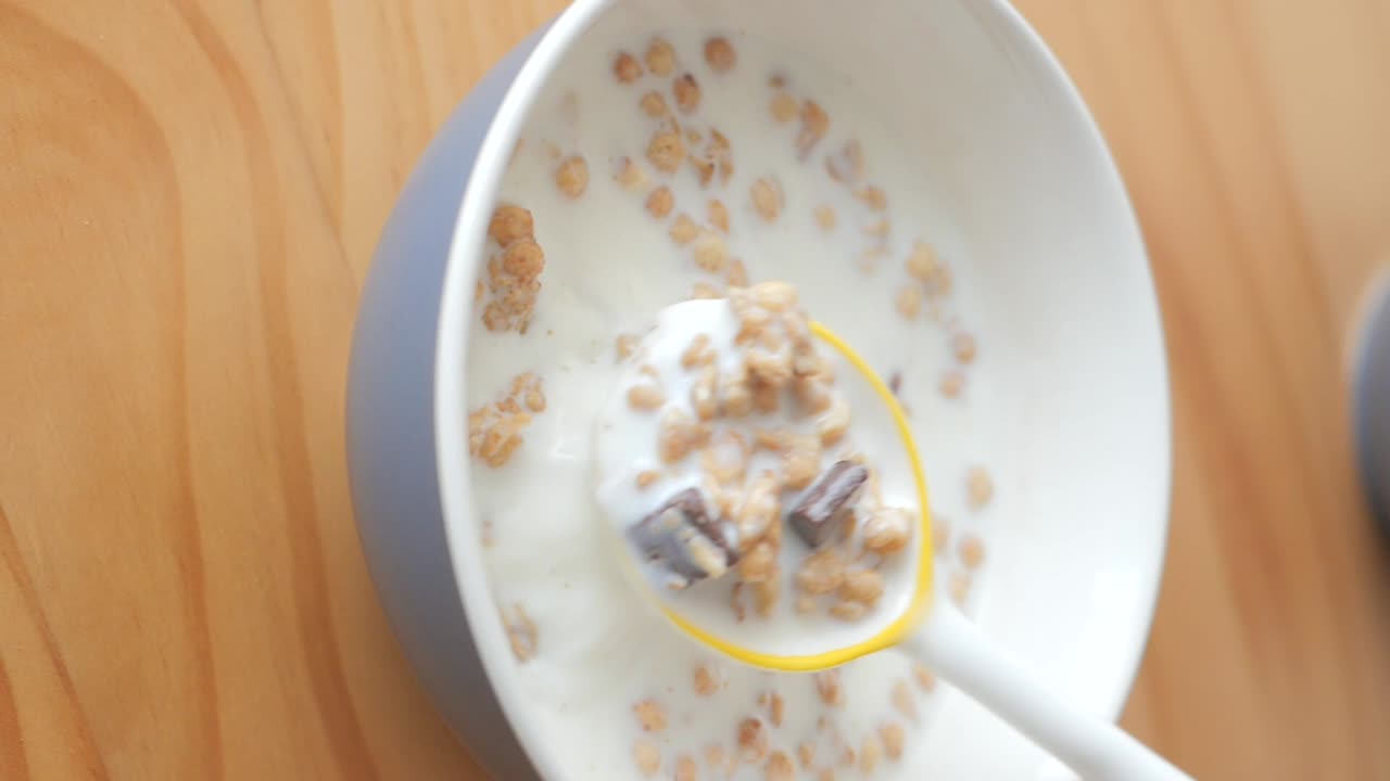 Mescolare cereali con latte e cioccolato in una ciotola