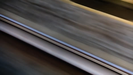 Close-up-of-guardrail-during-train-trip
