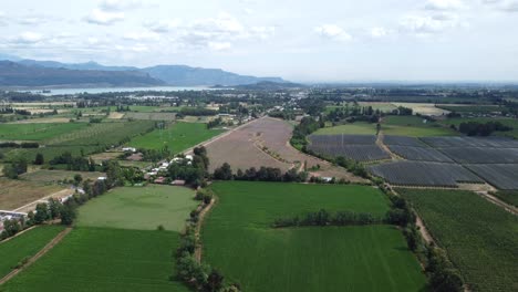 Vuelo-De-Drones-Pasando-Entre-Un-Campo-Y-Llegando-Al-Lago