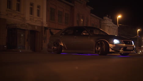 modified car on a city street at night