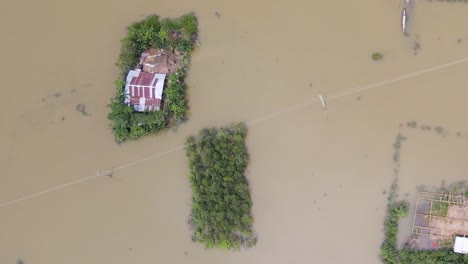 floating homes in the village on a flooded landscape in bangladesh, south asia. aerial topdown shot