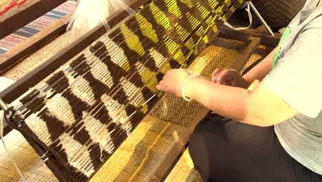 woman weaving on a traditional loom