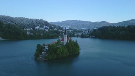 a church on a small island in the middle of lake bled in slovenia