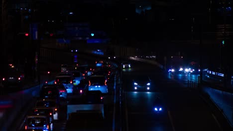 a night timelapse of the traffic jam at the city street in tokyo long shot