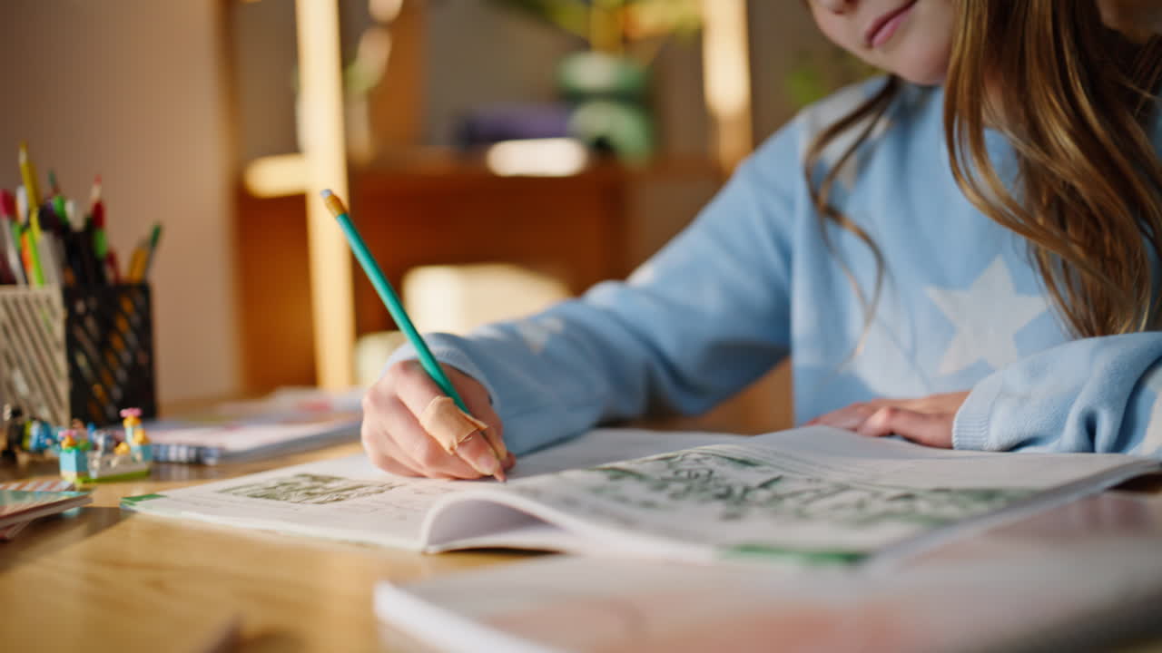 Pupil hand writing notebook apartment closeup. Intelligent girl making notes