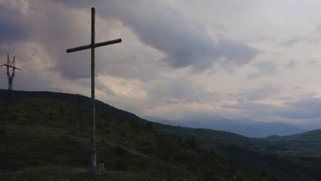 large wooden cross overlooking akaltsikhe valley beneath dusking sky