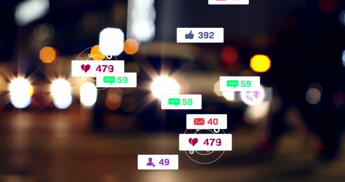 Animation of social media icons and numbers over out of focus city lights