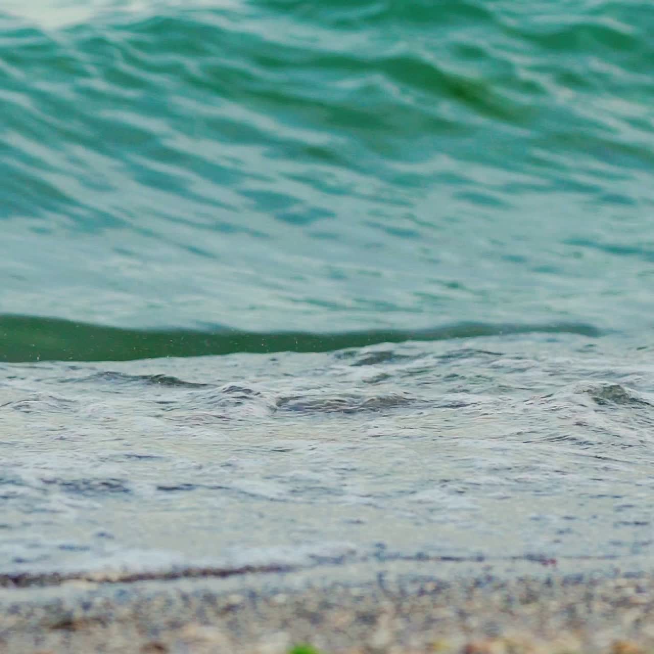 Wave of the sea on the sand beach. Big sea wave. Slow motion