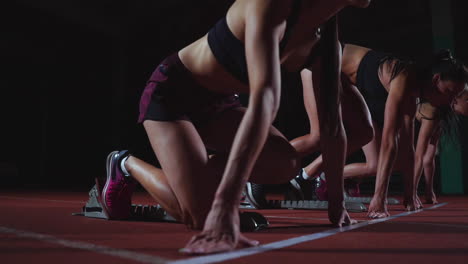 female athletes warming up at running track before a race. in slow motion