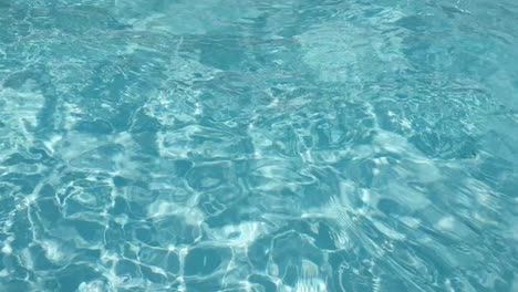 Pure-blue-turquoise-crystal-pool-water-with-light-reflections