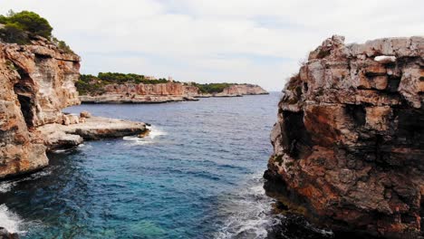 aerial shot of es pontas famous natural arch and cliffs in the south east coast of the island of mallorca