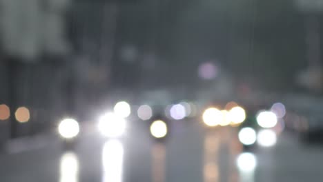 blurry footage of highway with vehicle headlights during heavy rain condition