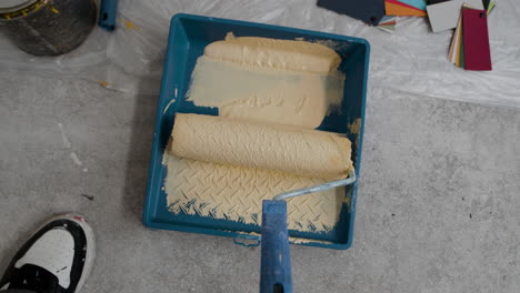 painting a wall with yellow and beige paint
