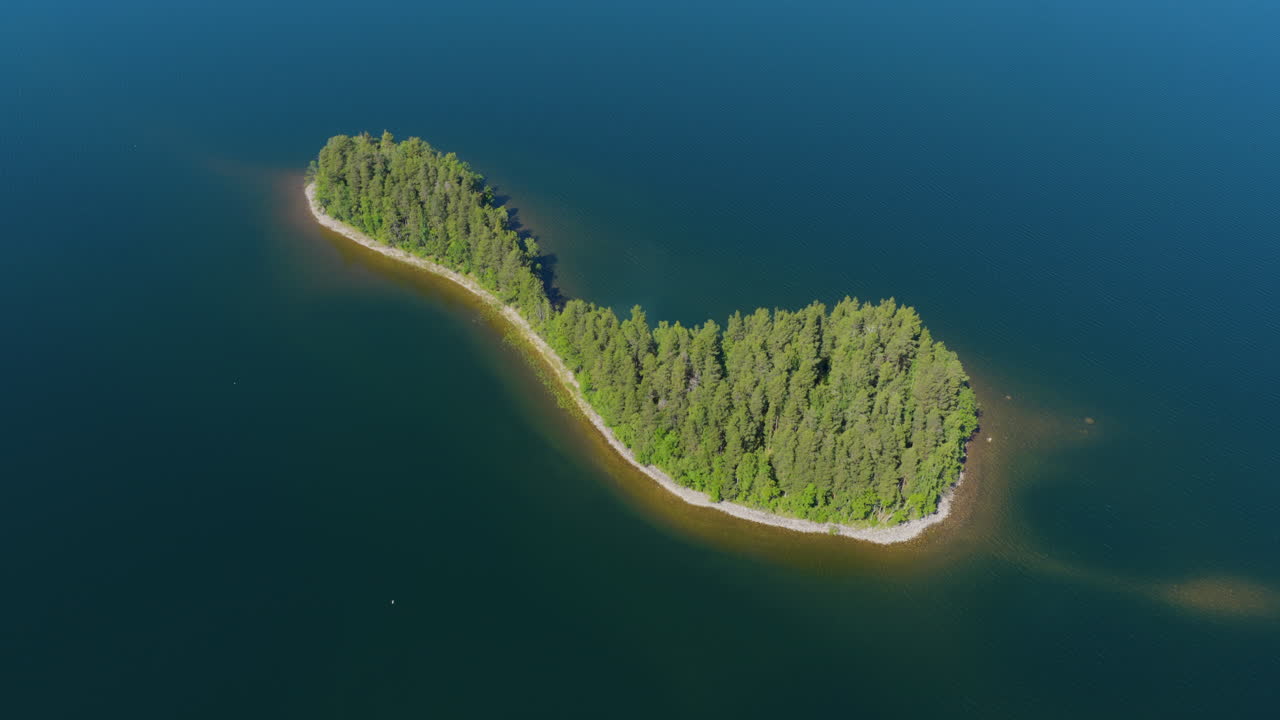 Drone orbiting the Petkele island on Lake Puruvesi, sunny, summer day in Finland