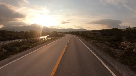 Driving-a-Car-on-a-Road-in-Norway-at-dawn