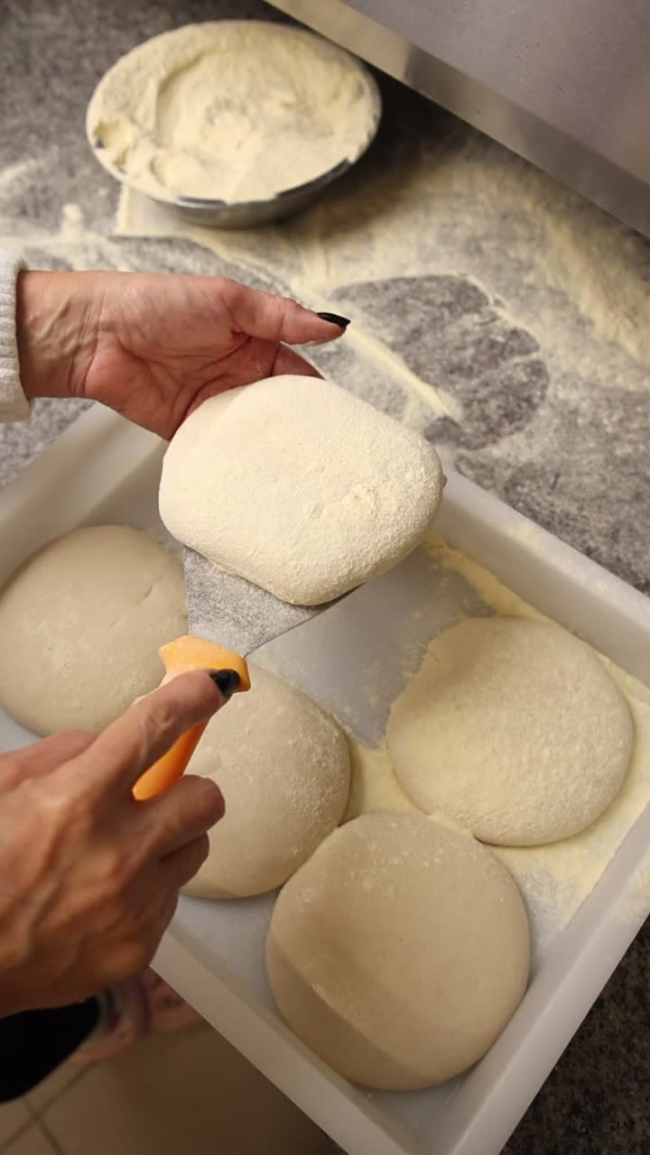 Chef's Hands Preparing Fresh Pizza Dough Balls with Flour