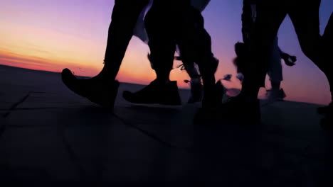 silhouettes of people walking or running at sunset or sunrise