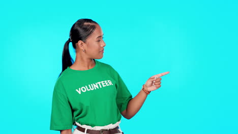 Volunteer-woman-pointing-to-empty-space-isolated