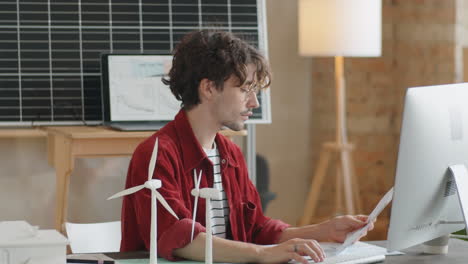 renewable energy engineer working on computer in office