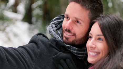 Couple-talking-a-selfie-with-mobile-phone-on-a-winter-day