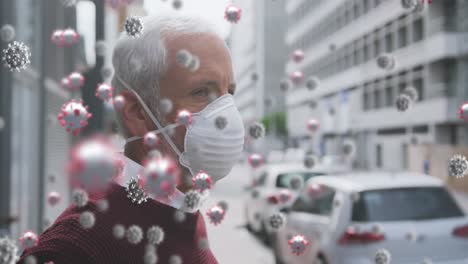 Animation-of-covid-19-cells-over-senior-man-wearing-face-mask